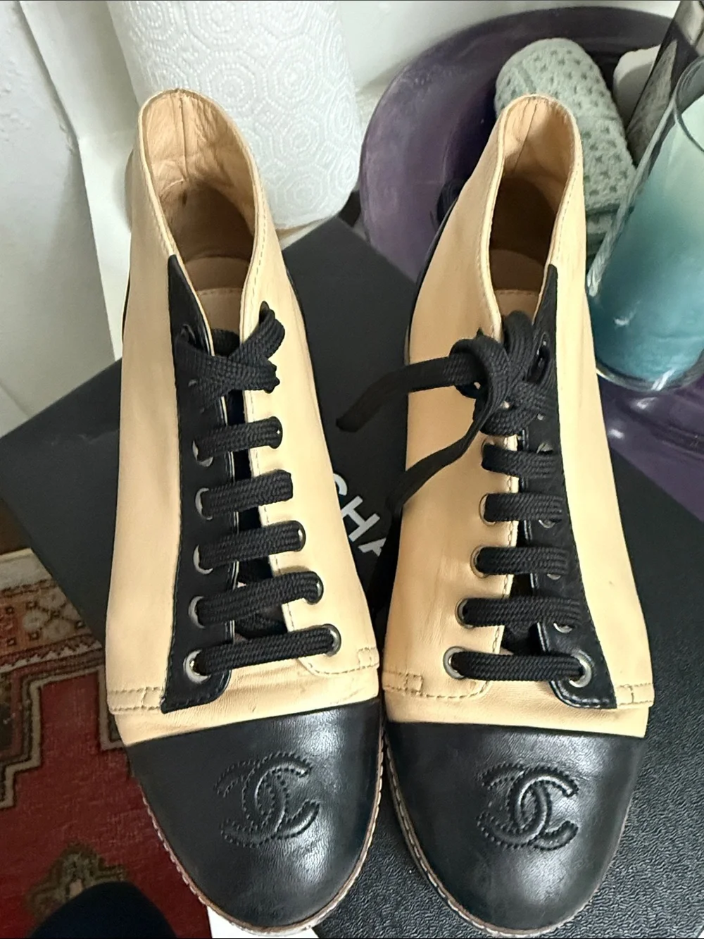CHANEL Two-Tone Leather High-Top Sneakers in Beige & Black